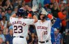 Houston Astros' Yuli Gurriel is greeted by teammate Michael Brantley after his two-run home run against the Texas Rangers in the fifth inning of a baseball game Saturday, July 20, 2019, in Houston. (AP Photo/Richard Carson)