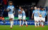 Huddersfield Town's Steve Mounie, back left, celebrates scoring his side's first goal of the game in the 90th minute during the Premier League match at the John Smith's Stadium, Huddersfield, Tuesday February 26, 2019. (Martin Rickett/PA via AP)