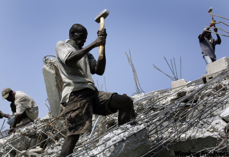 JORGE SAENZ / THE ASSOCIATED PRESS
Haitian man demolishes a collapsed building in the Pacot neighbourhood of Port-au-Prince.