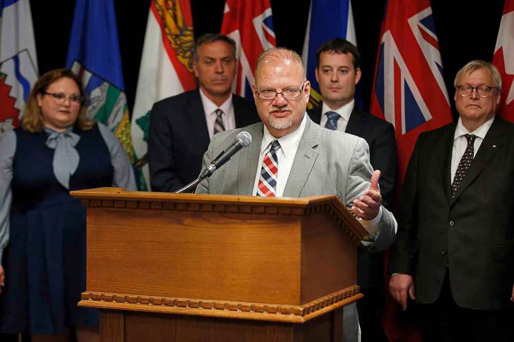 CP
Kelvin Goetrzen, Manitoba Minister of Health, Seniors and Active Living responds to a reporter's questions as from left, Sarah Hoffman, Alberta Minister of Health, Robert Mitchell, Prince Edward Island Minister of Health and Wellness, Randy Delorey, Nova Scotia Minister of Health and Wellness, and Gaetan Barrette, Quebec Minister of Health and Social Services, listen in at a press conference during the Conferences of Provincial-Territorial Ministers of Health in Winnipeg, Thursday, June 28, 2018. THE CANADIAN PRESS/John Woods