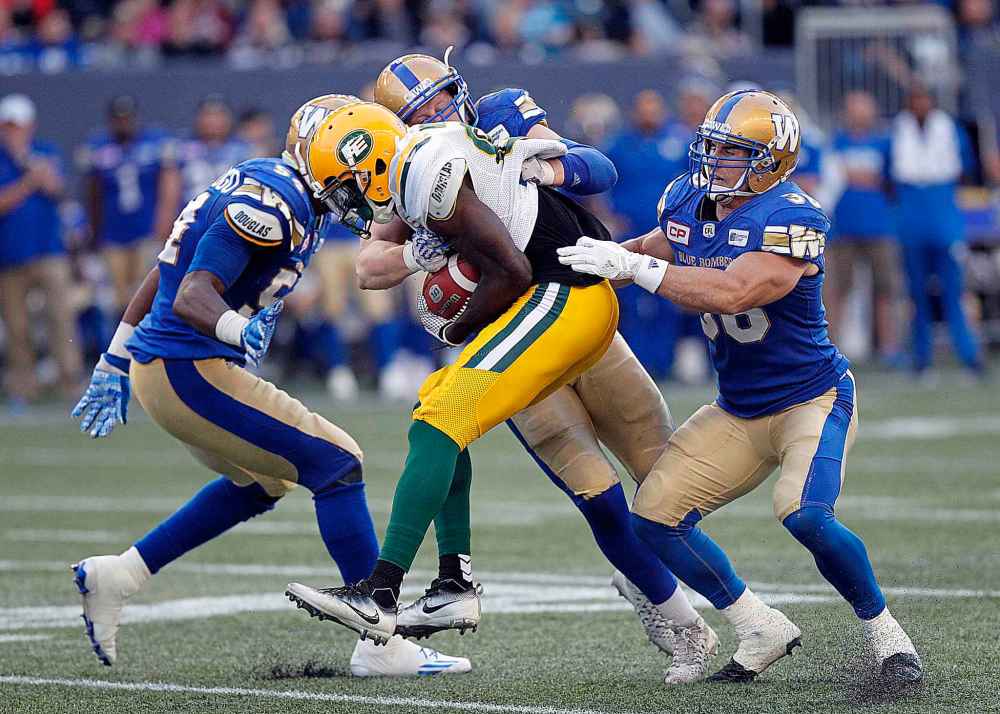 PHIL HOSSACK / WINNIPEG FREE PRESS
Edmonton Eskimos' Bryant Mitchell is gang tackled by, from left to right, Winnipeg Blue Bombers' Tristan Okpalaugo, Sam Hurl and Ian Wild Thursday evening at Investors Group Field.