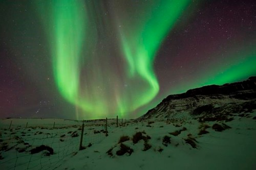 FILE - In this March 1, 2017 file photo, the Northern Lights, or aurora borealis, appear in the sky over Bifrost, Western Iceland. Police in Iceland say tourists are often putting themselves at risk searching for the Northern Lights, whose spectacular streaks of color light up the winter skies at night. Police say sleep-deprived tourists are dividing their attentions between the road and the sky, and often underestimate the challenging conditions posed by Iceland‚Äôs twisty, narrow, often-icy roads in the winter. (AP Photo/Rene Rossignaud, File)