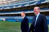 Chicago Fire owner Joe Mansueto, left, walks onto the pitch at Soldier Field with major League Soccer Commissioner Don Garber before Mansueto announced that the soccer team will play their 2020 season in Soldier Field Tuesday, Oct. 8, 2019, in Chicago. (AP Photo/Charles Rex Arbogast)