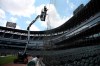 Workers from C&H Baseball company install additional protective netting at Guaranteed Rate Field in Chicago on Wednesday, July 10, 2019. The netting is being extended from the dugouts to the fair poles in right and left field. (Terrence Antonio James/Chicago Tribune via AP)