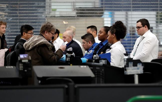 Transportation Security Administration officers work at a checkpoint at O'Hare airport in Chicago, Friday, Jan. 11, 2019, as the partial government shutdown continues. (AP Photo/Nam Y. Huh)