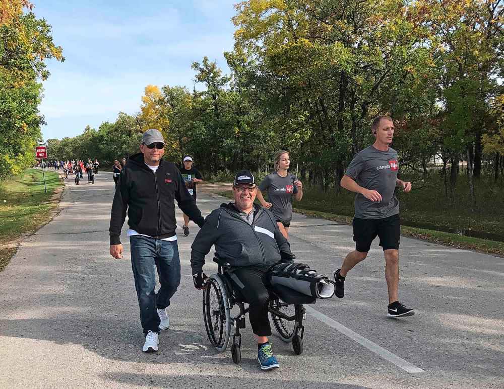 TESSA VANDERHART / WINNIPEG FREE PRESS
Cam Irving, with friend Derek Klassen, lost a brother to cancer and despite losing a leg in May, finished the Terry Fox Run Sunday.