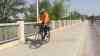 Tyler Walsh / Winnipeg Free Press
A. Bass Bagayogo rides on the sidewalk along St. Mary's Road. On some portions of the route, he thinks it's safer than battling the traffic and parked cars on the road.