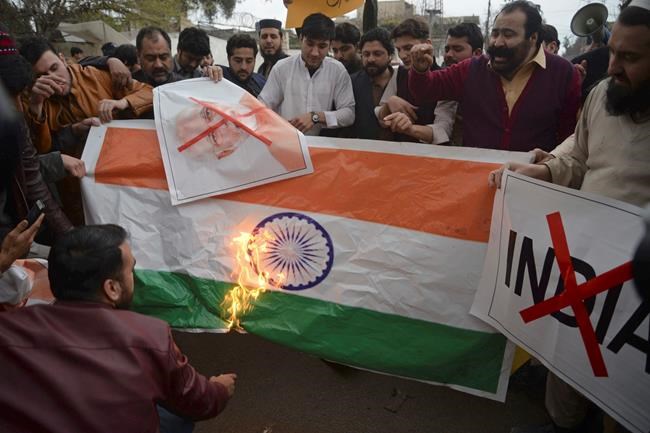 Pakistani protesters burn a representation of an Indian flag during an anti-Indian rally in Peshawar, Pakistan, Tuesday, Feb. 26, 2019. Pakistan said India launched an airstrike on its territory early Tuesday that caused no casualties, while India said it targeted a terrorist training camp in a pre-emptive strike that killed a