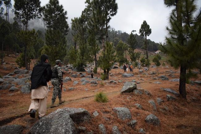 Pakistani reporters and troops visit the site of an Indian airstrike in Jaba, near Balakot, Pakistan, Tuesday, Feb. 26, 2019. Pakistan said India launched an airstrike on its territory early Tuesday that caused no casualties, while India said it targeted a terrorist training camp in a pre-emptive strike that killed a
