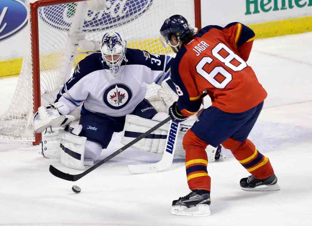 Alan Diaz / The Associated Press
Winnipeg Jets goalie Michael Hutchinson (34) prepares to block a shot by Florida Panthers right wing Jaromir Jagr (68) during the first period of an NHL hockey game, Saturday.