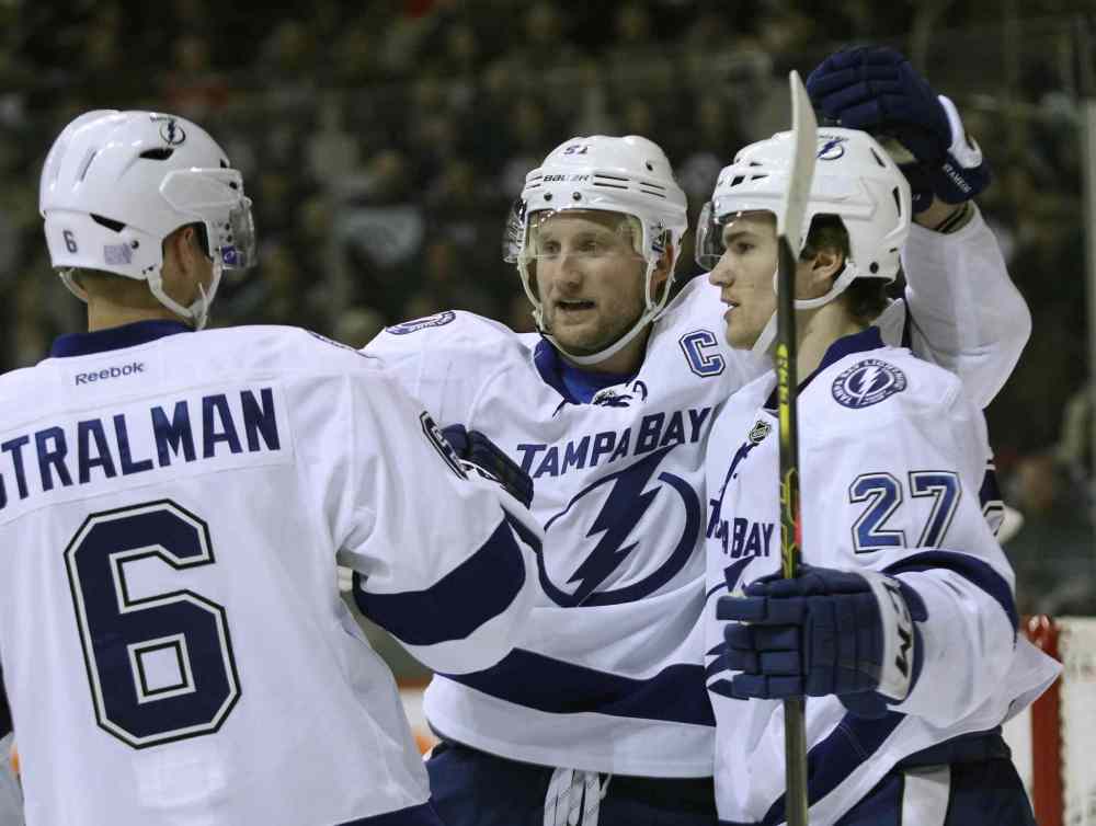 JOE BRYKSA / WINNIPEG FREE PRESS
Tampa Bay Lightning Anton Stralman, left, and Jonathan Drouin, right, congratulate their teammate Steven Stamkos on his first period goal against the Winnipeg Jets at the MTS Centre.