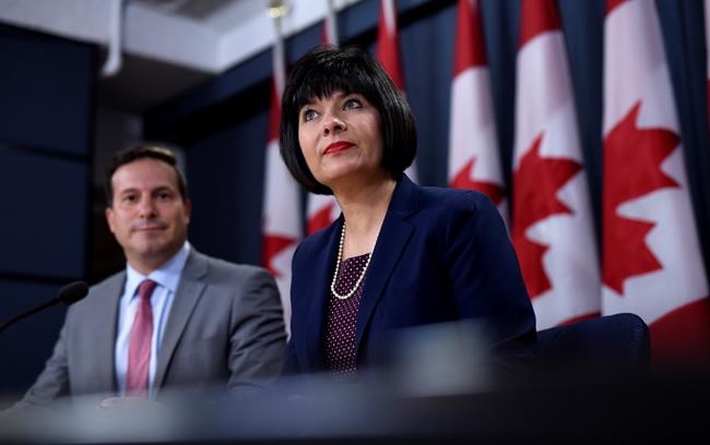 Minister of Health, Ginette Petitpas Taylor and Liberal MP Marco Mendicino, left, speak at a press conference regarding the Canada Food Guide and their letter to Conservative leader Andrew Scheer, at the National Press Theatre in Ottawa on Monday, July 22, 2019. THE CANADIAN PRESS/Justin Tang
