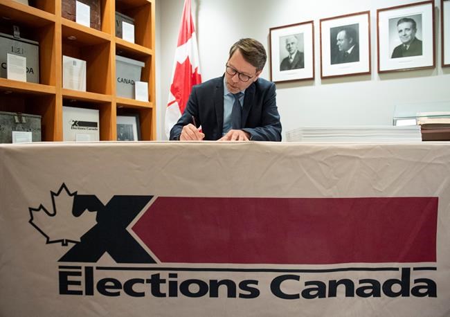 Chief Electoral Officer Stephane Perrault signs the writs of the 43rd general election during a photo opportunity in Gatineau, Que., Friday, Sept. 20, 2019. THE CANADIAN PRESS/Justin Tang