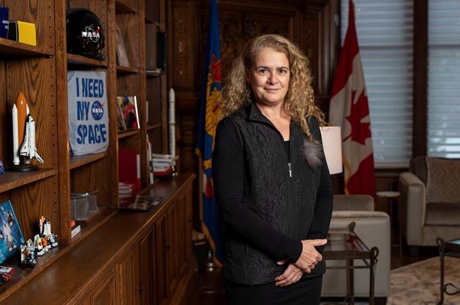 Governor General Julie Payette stands next to a shelf featuring memorabilia from her career as an astronaut, in her office at Rideau Hall in Ottawa on Tuesday, Dec. 11, 2018. THE CANADIAN PRESS/Justin Tang