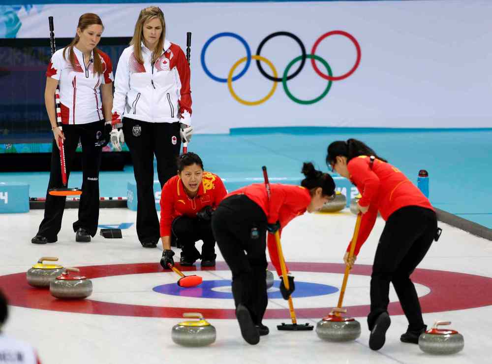 Robert F. Bukaty / the associated press
China’s Liu Yin shouts instructions to her sweepers as Canada’s Kaitlyn Lawes (left) and skip Jennifer Jones look on.