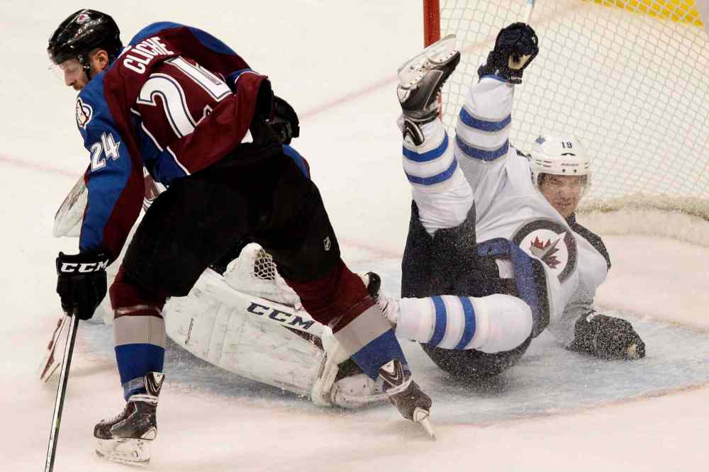 BARRY GUTIERREZ / THE ASSOCIATED PRESS
Winnipeg Jets centre Jim Slater is called for interfering with the goalie while Colorado Avalanche right-winger Marc-Andre Cliche clears the puck during the first period of an NHL game at Pepsi Center in Denver, Colo., Monday.