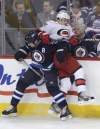 MIKE DEAL / WINNIPEG FREE PRESS
Winnipeg Jets defenceman Mark Stuart pins Carolina Hurricanes' Tuomo Ruutu against the boards during the first period of an NHL game at the MTS Centre in Winnipeg Thursday.