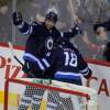 Boris Minkevich / Winnipeg Free Press
Winnipeg Jets Blake Wheeler (left) and Bryan Little celebrate a goal by captain Andrew Ladd against the New Jersey Devils at the MTS Centre Thursday. The goal came just eight seconds after the opening faceoff.