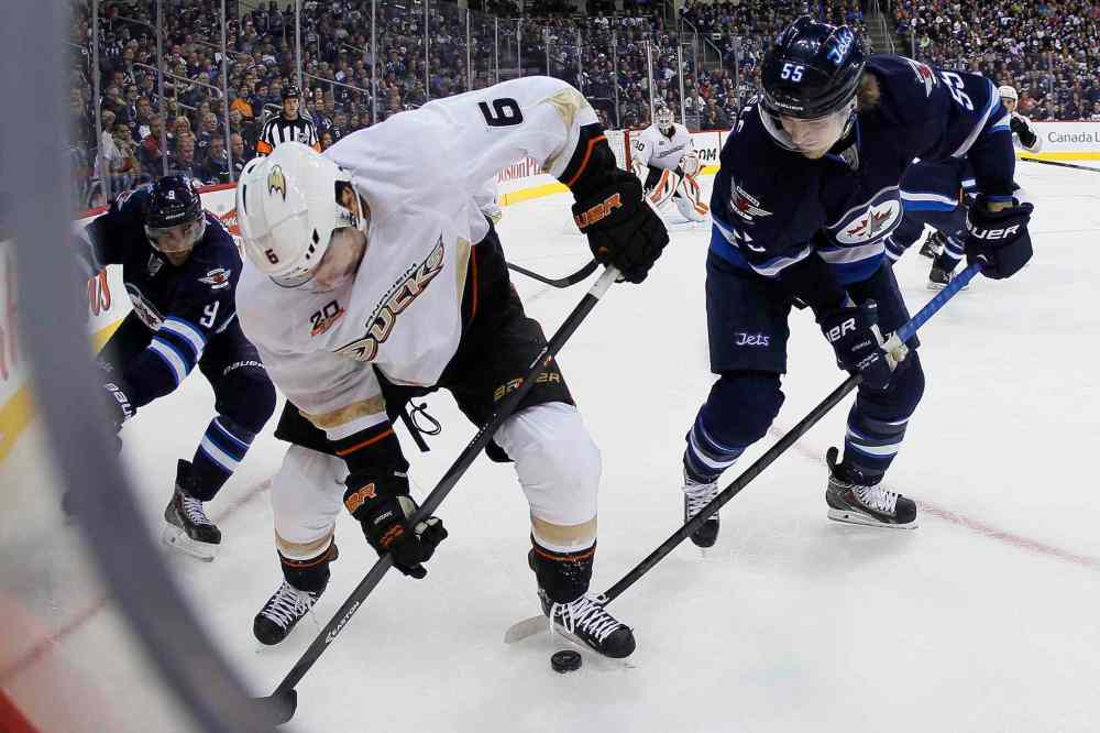 JOHN WOODS / WINNIPEG FREE PRESS
Winnipeg Jets Evander Kane (left) and Mark Scheifele pressure Anaheim's Ben Lovejoy in the corner on Sunday night at the MTS Centre.