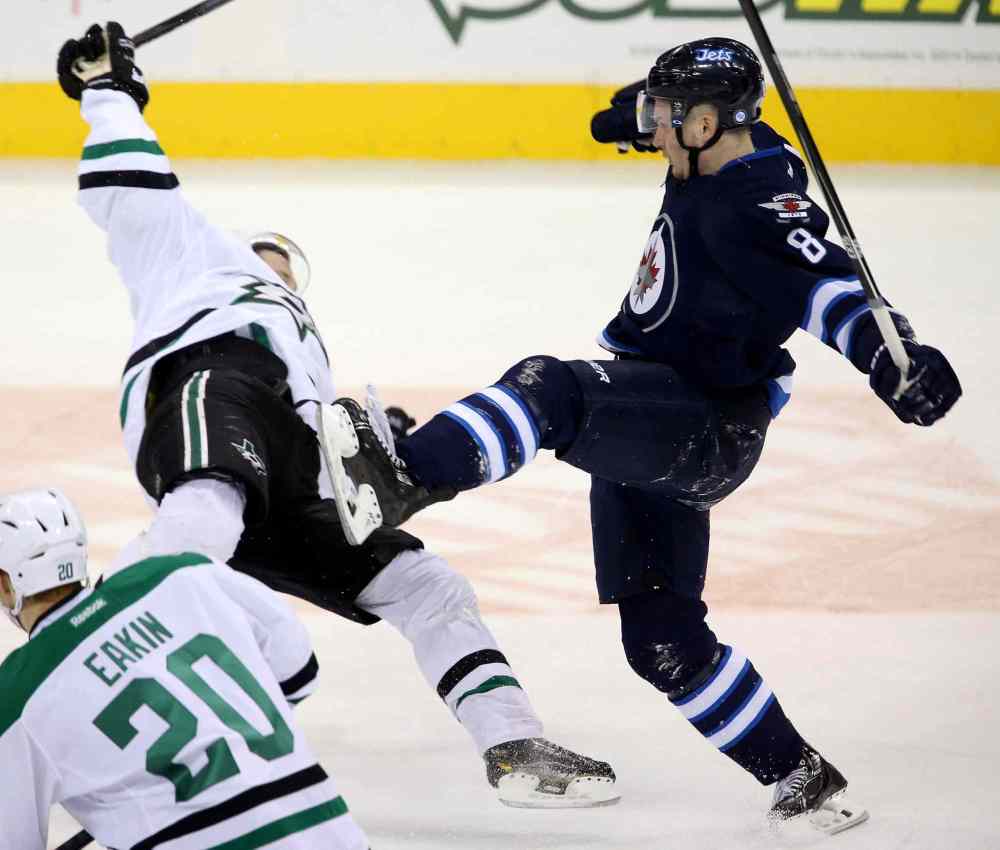 TREVOR HAGAN / THE CANADIAN PRESS
Dallas Stars’ left-winger Erik Cole is flattened by Winnipeg Jets defenceman Jacob Trouba in the first period Sunday night.