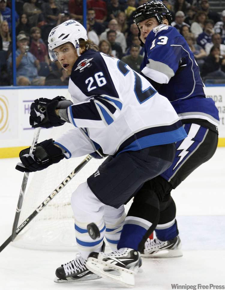 CP
Winnipeg Jets right wing Blake Wheeler (26) loses the puck after a check by Tampa Bay Lightning defenceman Pavel Kubina, of the Czech Republic, during the first period of an NHL hockey game on Saturday, Oct. 29, 2011, in Tampa, Fla. (AP Photo/Chris O'Meara)