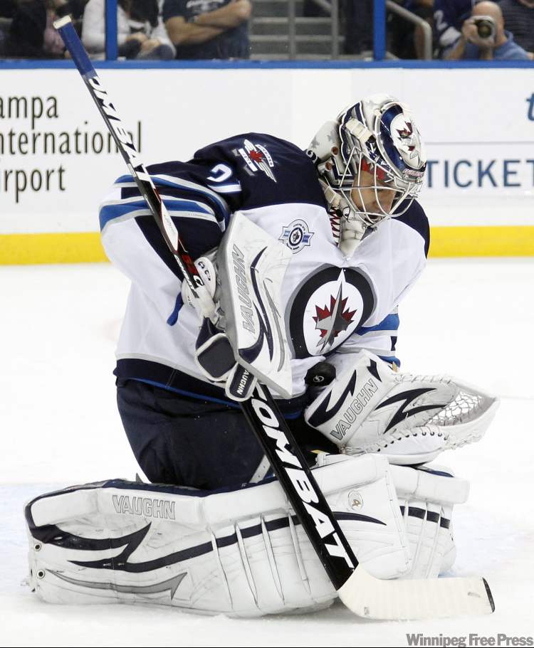 Chris O'Meara / The Associated Press
Winnipeg Jets goalie Ondrej Pavelec, of the Czech Republic, (31) makes a save on a shot by the Tampa Bay Lightning during the second period of an NHL hockey game Saturday, Oct. 29, 2011, in Tampa, Fla. (AP Photo/Chris O'Meara)