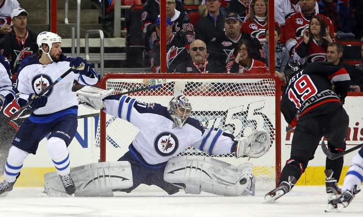 Karl B DeBlaker / the associated press
Carolina Hurricanes' Jiri Tlusty has his shot blocked by Winnipeg Jets goaltender Ondrej Pavelec as Jets defenceman Zach Bogosian defends during the first period of an NHL game in Raleigh, N.C., Tuesday.