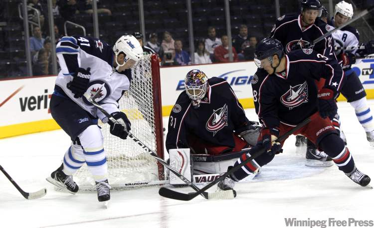 Boris Minkevich / Winnipeg Free Press
Winnipeg Jets' Jason Jaffray skates around Columbus net in first-period action Tuesday.