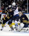 Gary Wiepert / the associated press
Buffalo Sabres defenceman Christian Ehrhoff (left) battles with Winnipeg Jets left-winger Andrew Ladd as Sabres goaltender Ryan Miller makes a save during the second period of an NHL hockey game in Buffalo, N.Y., Tuesday.