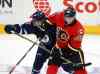 Jeff Bassett / The Canadian Press
Winnipeg Jets' Jansen Harkins gets held up by Calgary Flames' Ryan Culkin during first period NHL rookie action in Penticton, B.C. on Friday.