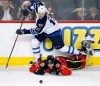 Larry MacDougal / The Canadian Press
Winnipeg Jets' Olli Jokinen takes a second-period tripping penalty on Calgary Flames' Kevin Westgarth during Friday's game in Calgary.
