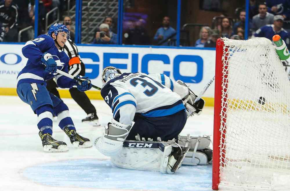 (Dirk Shadd/Tampa Bay Times/TNS)
The Tampa Bay Lightning's Yanni Gourde beats Winnipeg Jets goaltender Connor Hellebuyck in the first period.