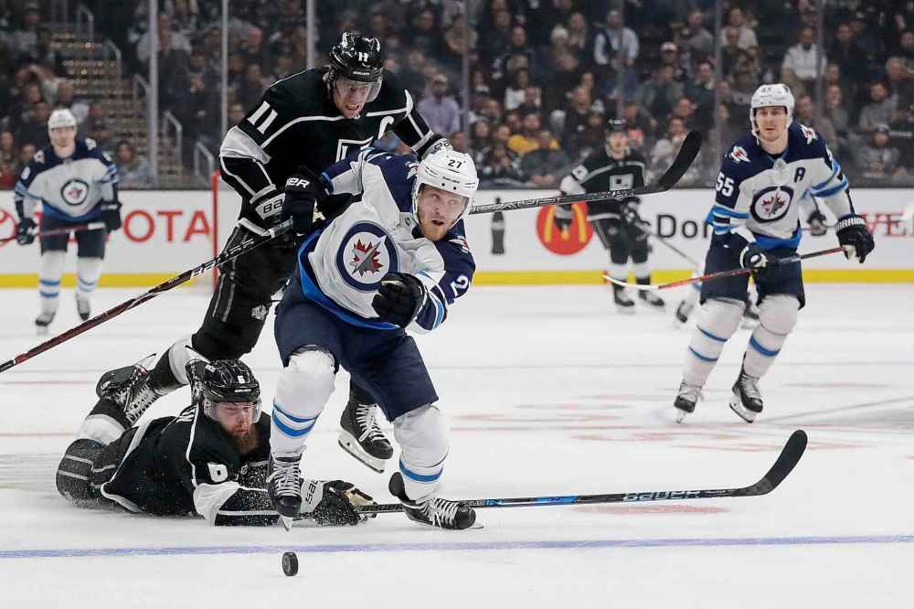 (AP Photo/Chris Carlson)
Winnipeg Jets left wing Nikolaj Ehlers pulls away from Los Angeles Kings defenceman Jake Muzzin, bottom, and centre Anze Kopitar during the third period in Los Angeles, Tuesday. The Kings won 4-1.