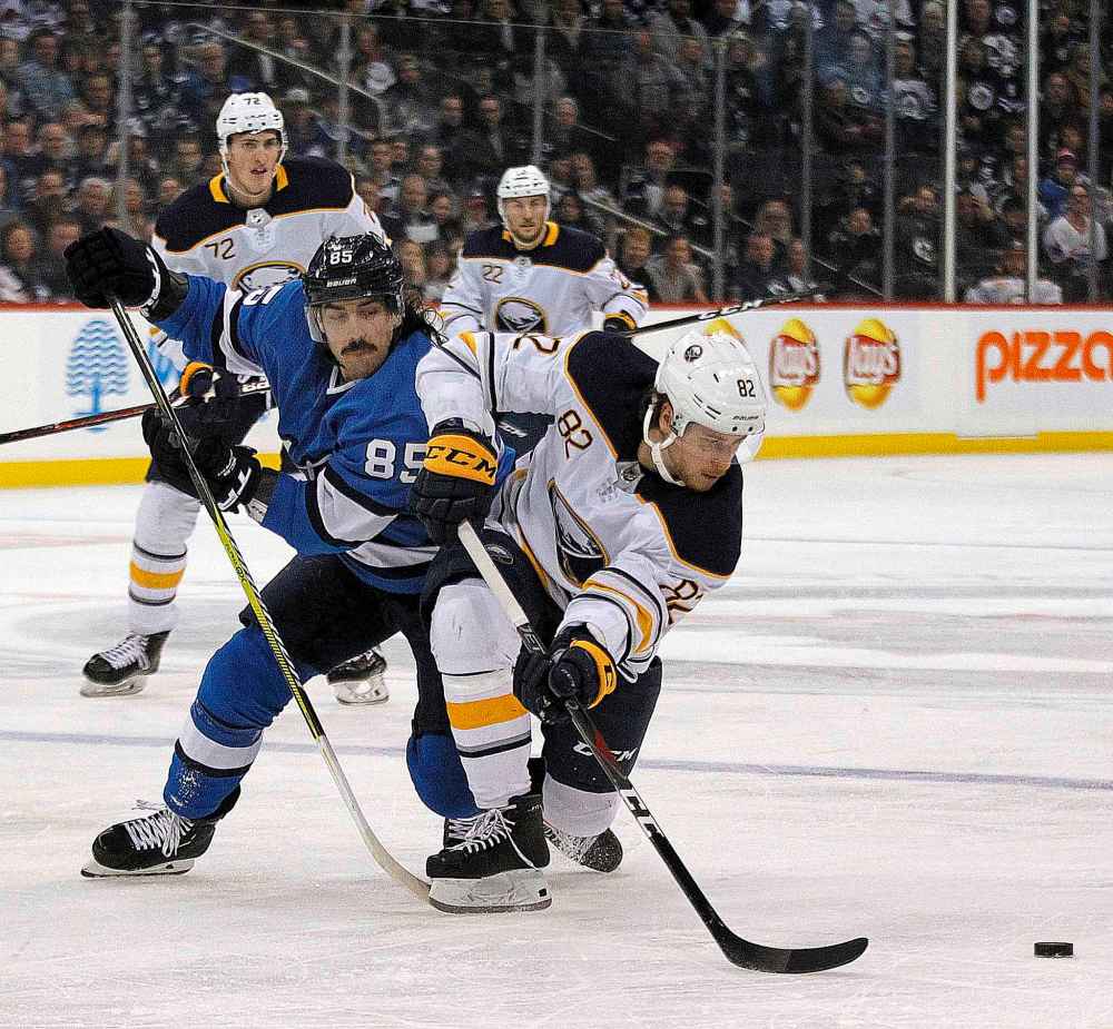 PHIL HOSSACK / WINNIPEG FREE PRESS
Winnipeg Jets' Matthieu Perreault pursues the and Buffalo Sabres' Nathan Beaulieu Friday.