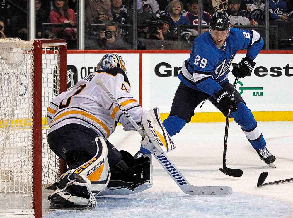 PHIL HOSSACK / WINNIPEG FREE PRESS
Patrik Laine lifts a backhand over Sabres net minder Carter Hutton Friday.