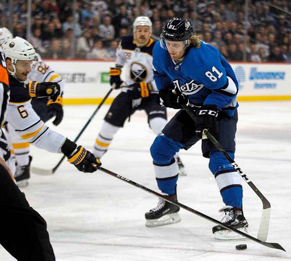 PHIL HOSSACK / WINNIPEG FREE PRESS
Winnipeg Jets' Kyle Connor toe drags around Buffalo Sabres' Marco Scandella during the second period Friday.