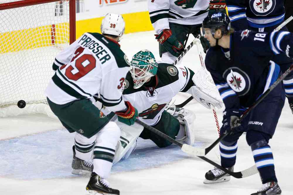JOHN WOODS / THE CANADIAN PRESS
Bryan Little scores on Josh Harding Thursday in Winnipeg.