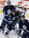 PHIL HOSSACK / WINNIPEG FREE PRESS
The Winnipeg Jets’ Dustin Byfuglien (33) and the Minnesota Wild’s Nino Niederreiter (22) fight for position in front of Jets’ goaltender Al Montoya (35) Thursday. A leaner, meaner Buff looks like he could be a force this year.
