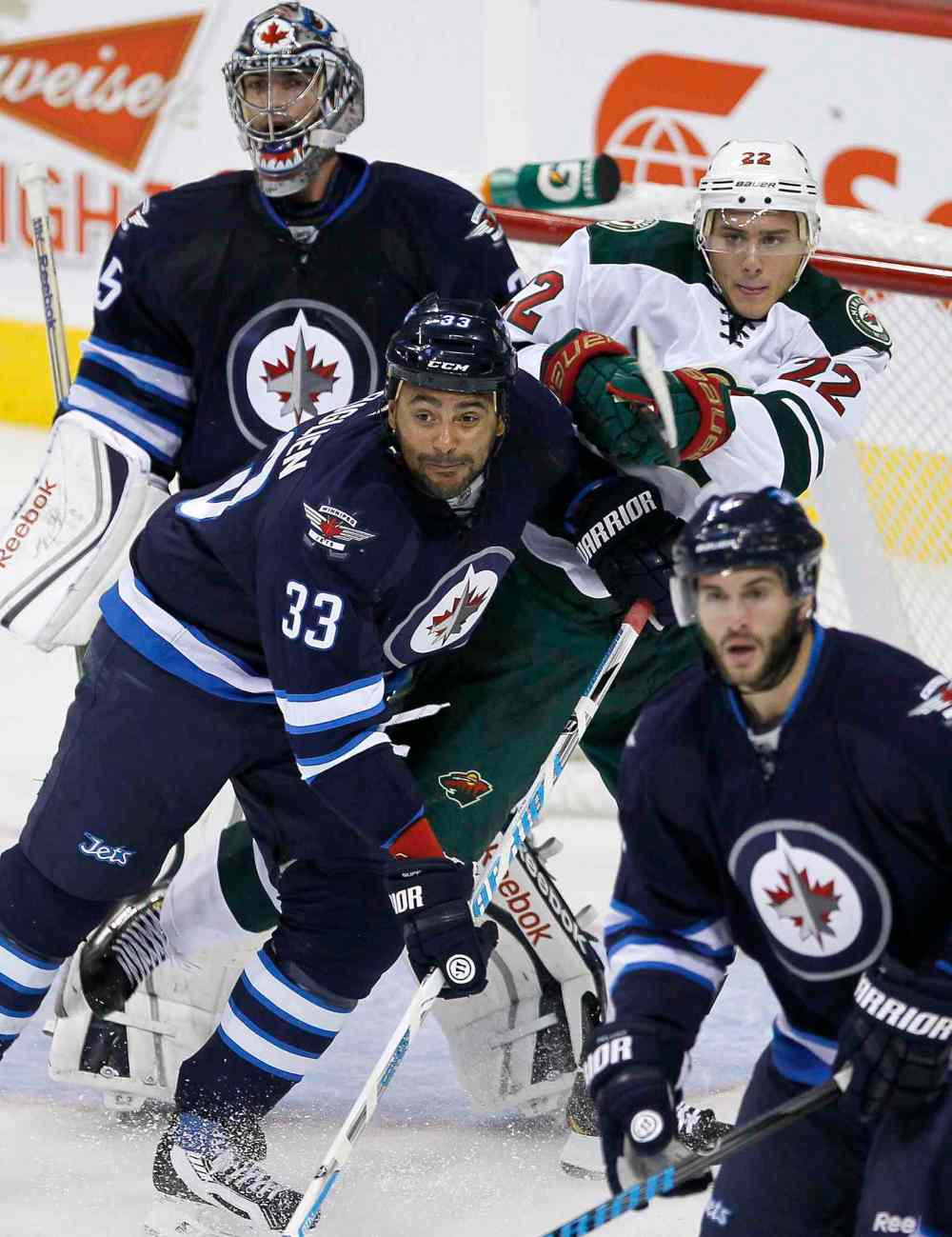 PHIL HOSSACK / WINNIPEG FREE PRESS
The Winnipeg Jets’ Dustin Byfuglien (33) and the Minnesota Wild’s Nino Niederreiter (22) fight for position in front of Jets’ goaltender Al Montoya (35) Thursday. A leaner, meaner Buff looks like he could be a force this year.