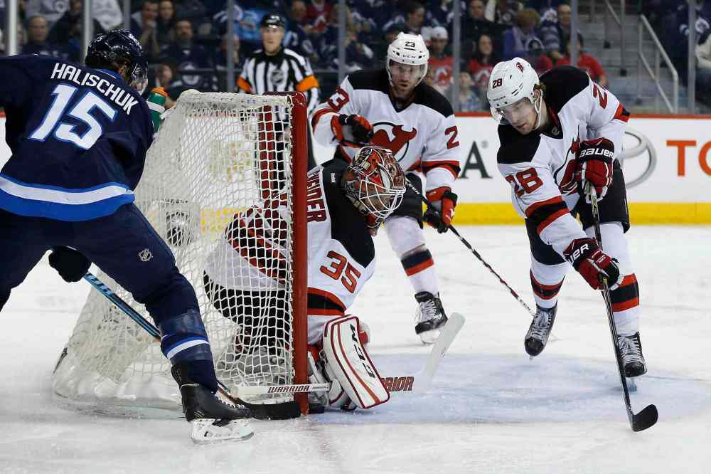 John Woods / The Canadian Press
Winnipeg's Matt Halischuk attempts a wraparound but comes up short. The Jets didn't have much luck against Cory Schneider and the Devils.