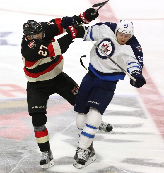Fred Chartrand / The Canadian PressWinnipeg Jets' Mark Scheifele (55) collides with Ottawa Senators' Curtis Lazar during the second period Thursday. The Jets erased a 2-0 deficit in the game, but fell 3-2 in a shootout.