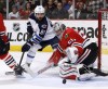 Charles Rex Arbogast / The Associated Press 
Chicago Blackhawks goalie Corey Crawford (50) makes a save as Winnipeg Jets centre Mathieu Perreault looks for a rebound on Tuesday in Chicago.