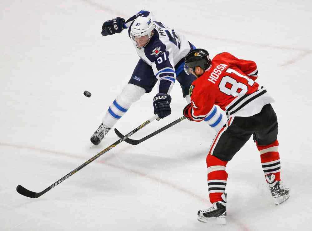 Kamil Krzaczynski / The Associated Press
Chicago Blackhawks right wing Marian Hossa (81) shoots the puck against Winnipeg Jets defenseman Tyler Myers (57) during the third period of an NHL hockey game Sunday, Dec. 6, 2015, in Chicago. The Blackhawks won 3-1.