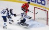 Kamil Krzaczynski / The Associated Press
Chicago Blackhawks center Dennis Rasmussen (70) tries to score against Winnipeg Jets goalie Connor Hellebuyck (37) during the second period of Sunday's game in Chicago. The Jets won 2-1.