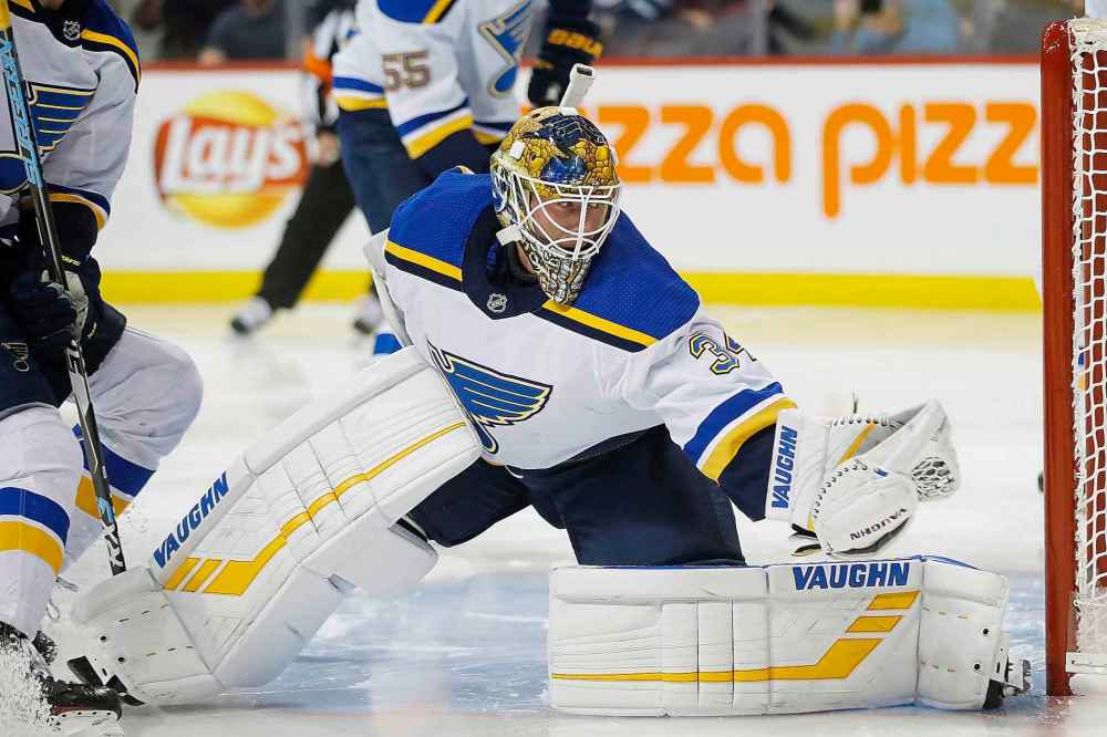 THE CANADIAN PRESS/John Woods
St. Louis Blues goaltender Jake Allen (34) saves the shot from Winnipeg Jets' Adam Lowry (17) as he looks for an opening during second period NHL action in Winnipeg on Friday, December 7, 2018.