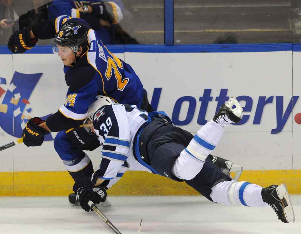 photos by Bill Boyce / The associated Press
Jets defenceman Toby Enstrom falls headfirst into the Blues' T.J. Oshie during their game in St. Louis last night.