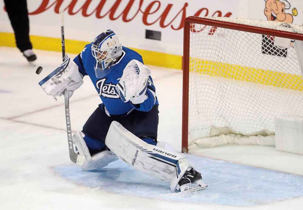 THE CANADIAN PRESS/Trevor Hagan
Winnipeg Jets' goaltender Laurent Brossoit makes a blocker save on a shot by the Chicago Blackhawks' during the first period in Winnipeg, Tuesday. It was the Blackhawks first shot of the game, more than 17 minutes after the first period started.