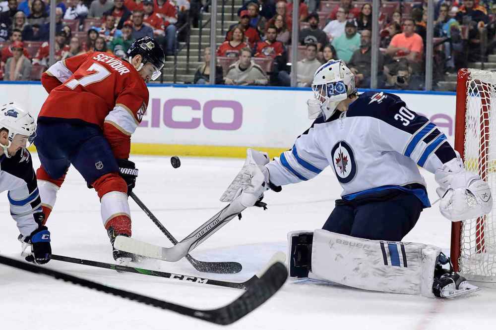 (AP Photo/Lynne Sladky)
Winnipeg Jets goaltender Laurent Brossoit blocks a shot as Florida Panthers' Colton Sceviour looks on during the first period.