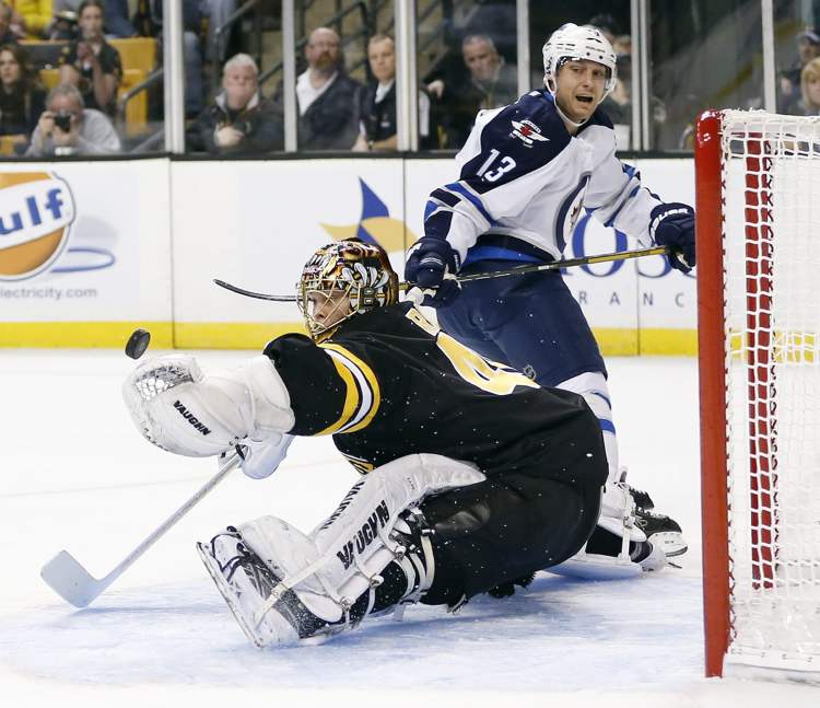 Michael Dwyer/ The Associated Press
Winnipeg Jets' Kyle Wellwood watches as his shot deflects off the glove of Boston Bruins' Tuukka Rask during the first period of a game in Boston today.