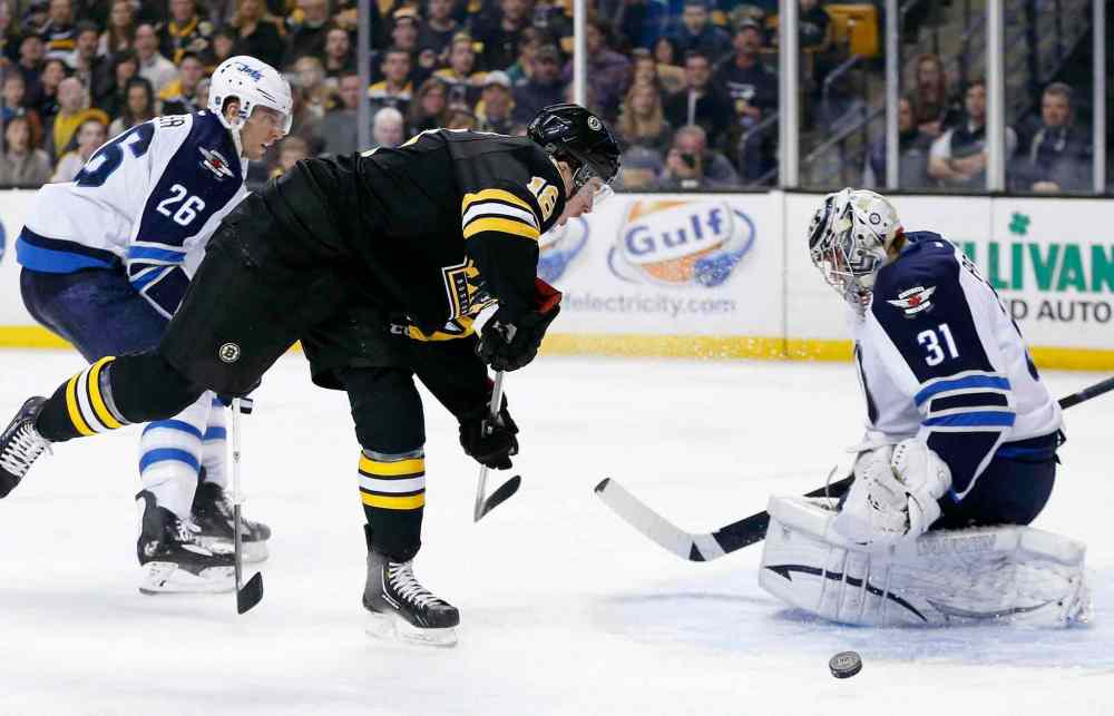 Michael Dwyer / The Associated Press
Ondrej Pavelec stops a shot by Boston Bruins' Reilly Smith in the second period in Boston, Saturday. The Jets lost the afternoon game 4-1.